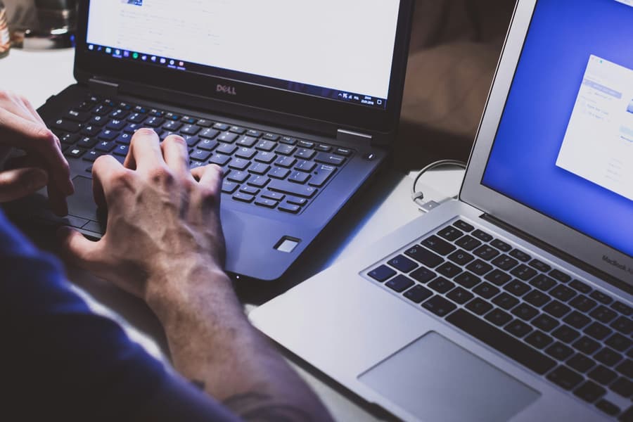 Two laptops used to review and approve an AI document processing workflow