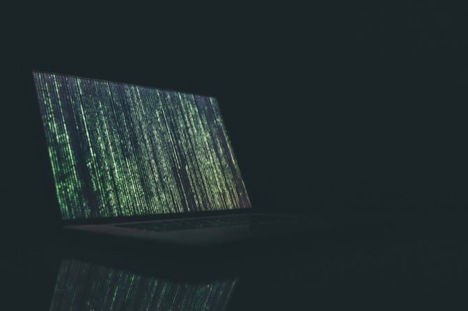 Developer laptop showing source code for a secure software delivery pipeline
